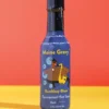 Maine Gravy Boothbay Blues hot sauce bottle on a colored background