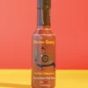 Maine Gravy Houlton Habanero hot sauce bottle on a colored background