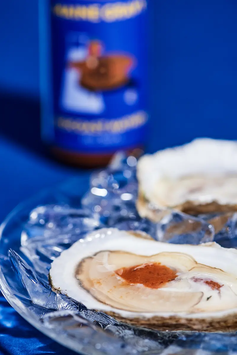 Oysters on ice with hot sauce
